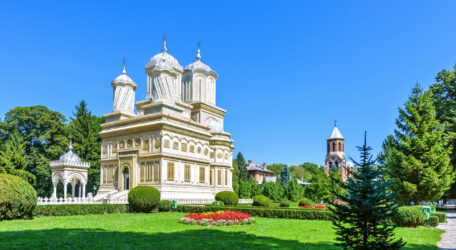 Daylight view to monastery garden park and cathedral on backgrou
